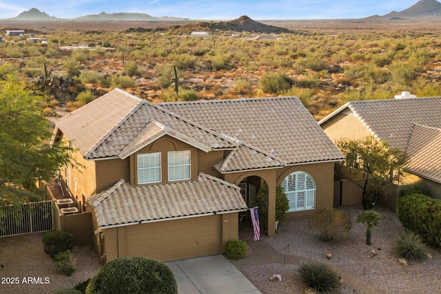 view of front facade with a garage and a mountain view