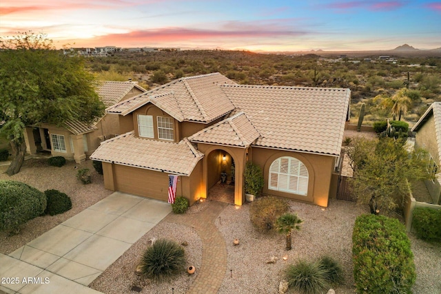 mediterranean / spanish-style home with a garage