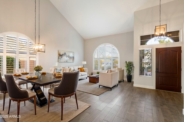 dining space featuring high vaulted ceiling, a chandelier, and hardwood / wood-style floors