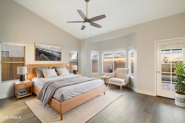 bedroom featuring multiple windows, access to outside, hardwood / wood-style floors, and ceiling fan