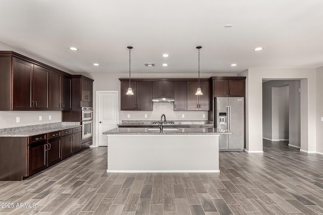kitchen with visible vents, dark brown cabinetry, light wood-style floors, under cabinet range hood, and appliances with stainless steel finishes