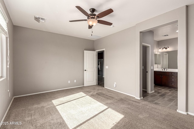 unfurnished bedroom featuring baseboards, carpet flooring, and visible vents