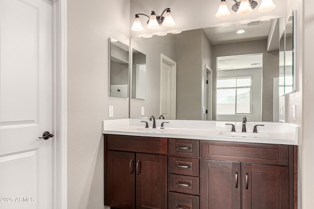 full bath featuring double vanity, visible vents, and a sink