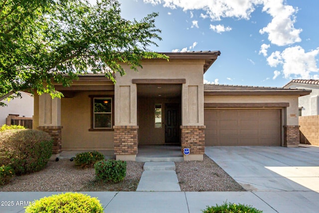view of front of house featuring an attached garage, driveway, and stucco siding