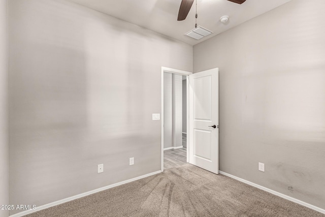 spare room featuring visible vents, carpet, ceiling fan, and baseboards