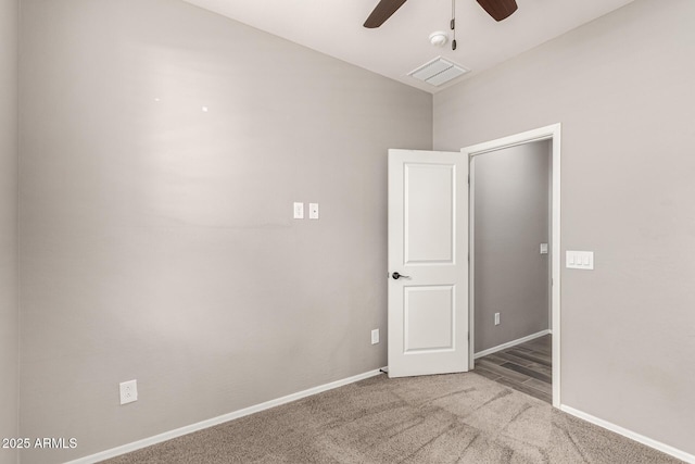 carpeted spare room featuring a ceiling fan, baseboards, and visible vents
