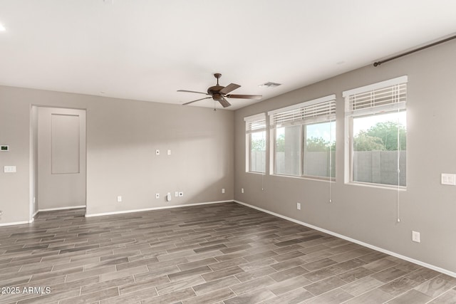 unfurnished room featuring light wood-style floors, baseboards, a ceiling fan, and visible vents