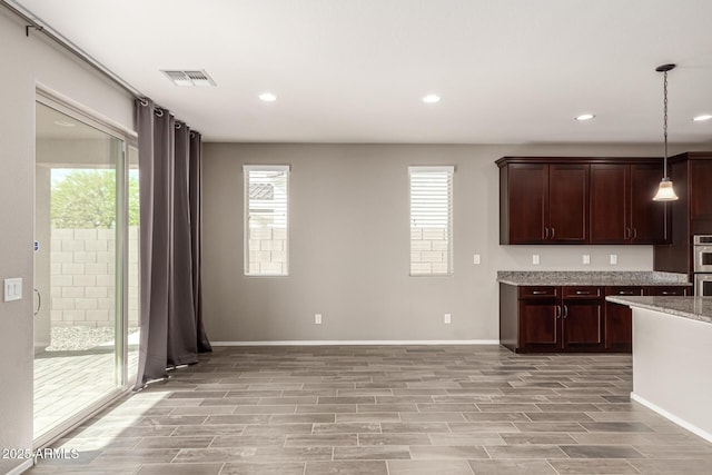 kitchen featuring light wood-style floors, baseboards, and a wealth of natural light