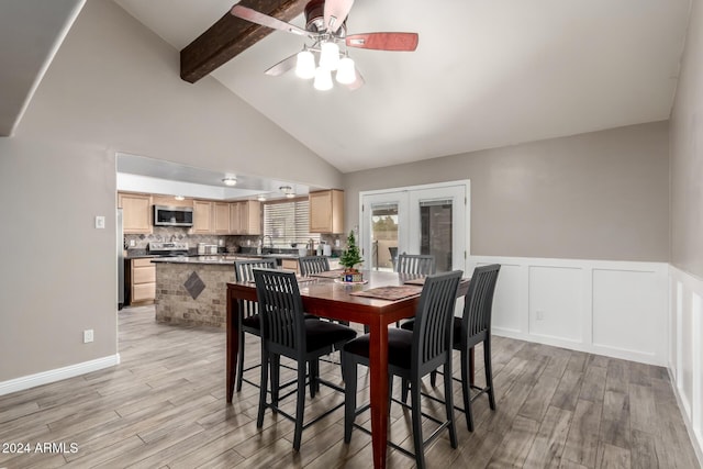 dining area featuring lofted ceiling with beams, ceiling fan, french doors, and light hardwood / wood-style floors