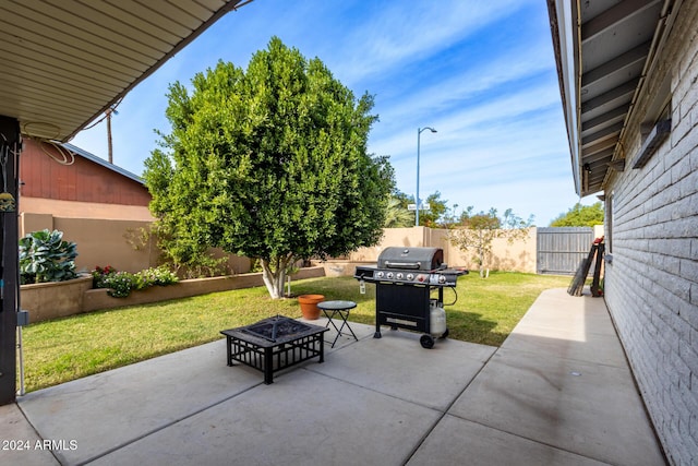 view of patio with a fire pit and a grill