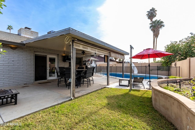 view of patio with a fenced in pool and ceiling fan