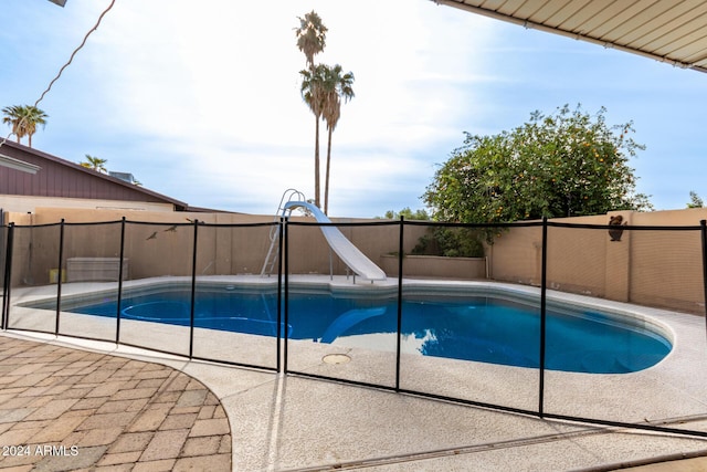 view of swimming pool with a water slide