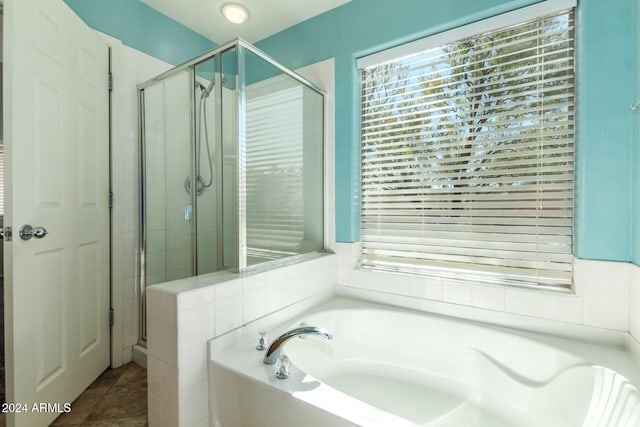 bathroom featuring tile patterned flooring and independent shower and bath