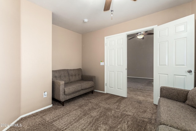 sitting room with ceiling fan and carpet