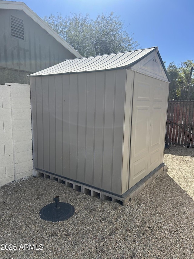 view of shed featuring fence