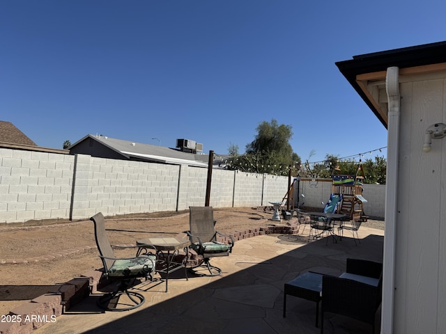 view of patio / terrace featuring a playground and a fenced backyard