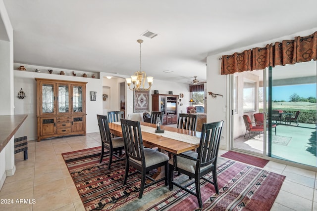 dining room featuring light tile patterned floors, ceiling fan with notable chandelier, arched walkways, and visible vents