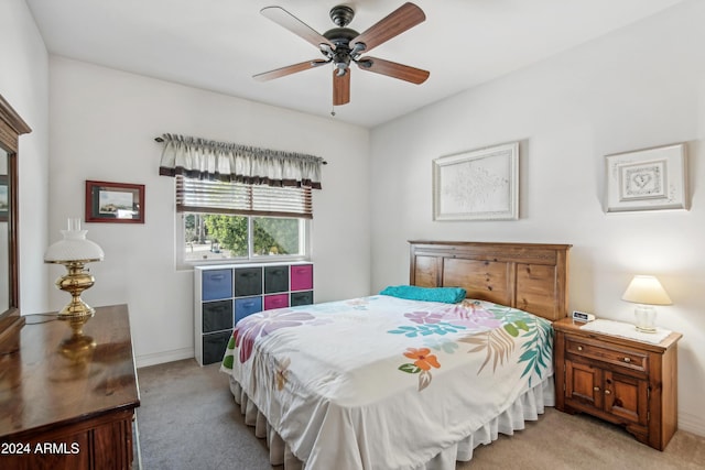 bedroom featuring baseboards, ceiling fan, and light colored carpet