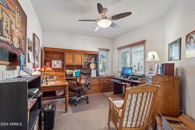 office featuring a ceiling fan and light carpet