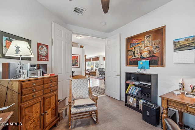 sitting room with carpet floors, ceiling fan, and visible vents