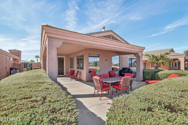 back of house with a patio area, fence, and stucco siding