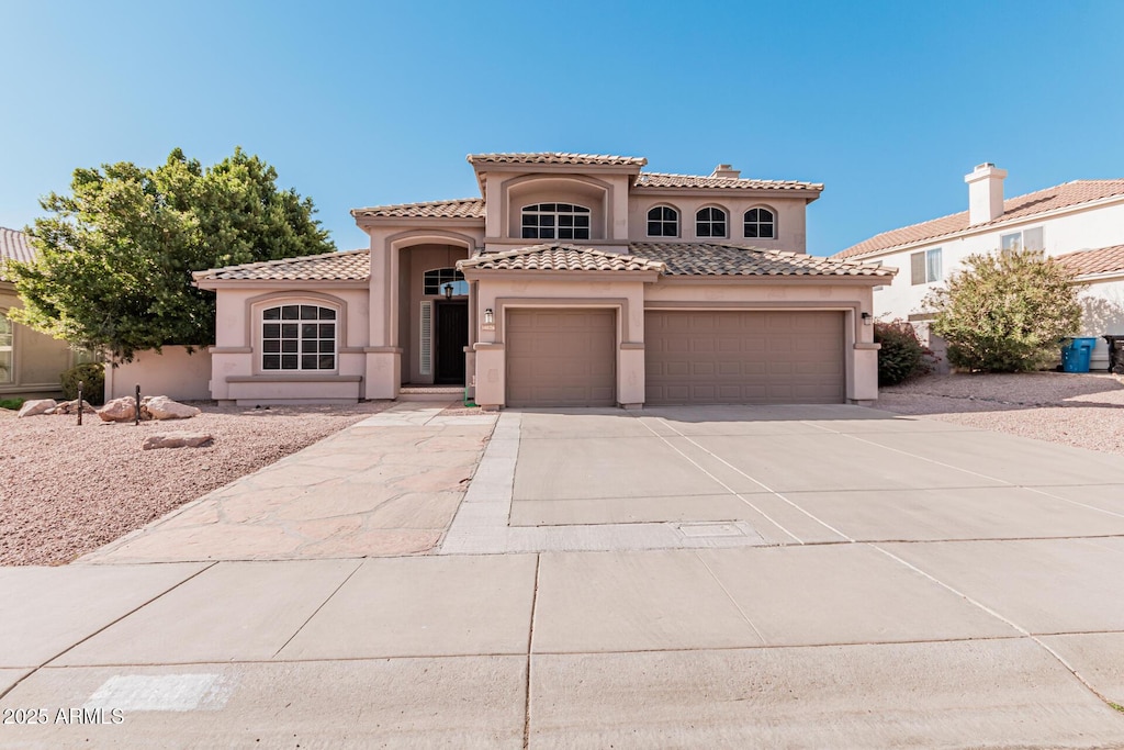 mediterranean / spanish-style home featuring a garage