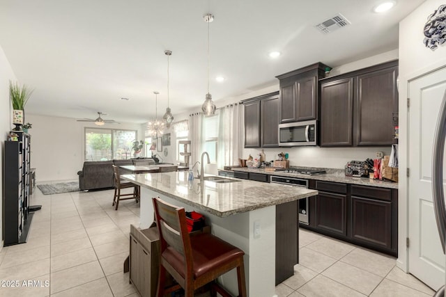 4269 W Coneflower Ln, San Tan Valley, AZ 85144 - kitchen featuring light tile patterned floors, light stone countertops, visible vents, appliances with stainless steel finishes, and a sink