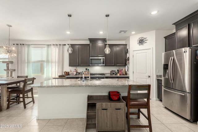4269 W Coneflower Ln, San Tan Valley, AZ 85144 - kitchen featuring light stone countertops, light tile patterned floors, a sink, and appliances with stainless steel finishes