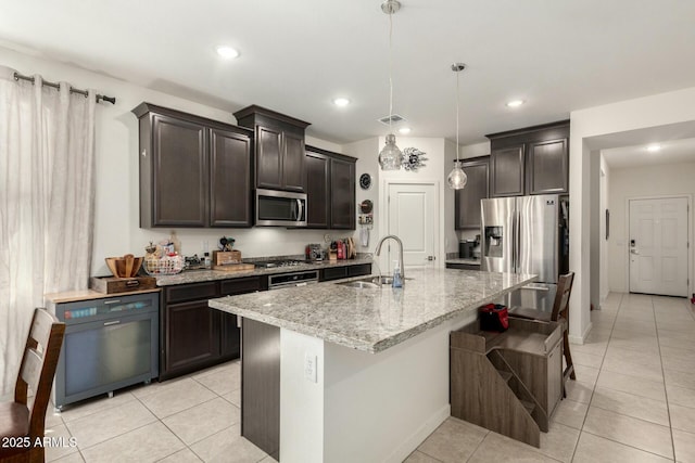 4269 W Coneflower Ln, San Tan Valley, AZ 85144 - kitchen with light tile patterned floors, visible vents, light stone counters, a sink, and stainless steel appliances