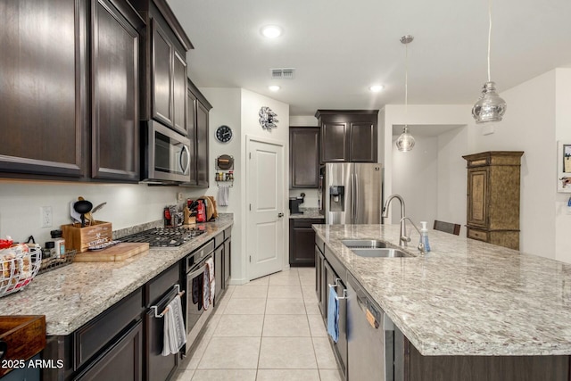 4269 W Coneflower Ln, San Tan Valley, AZ 85144 - kitchen with a large island, light stone counters, visible vents, appliances with stainless steel finishes, and a sink
