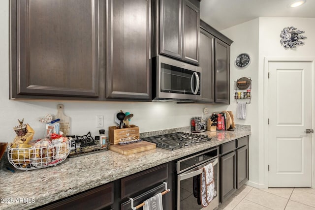 4269 W Coneflower Ln, San Tan Valley, AZ 85144 - kitchen featuring light stone countertops, light tile patterned floors, dark brown cabinets, and appliances with stainless steel finishes