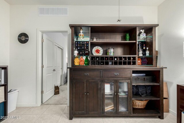 4269 W Coneflower Ln, San Tan Valley, AZ 85144 - bar with a bar, light tile patterned floors, visible vents, and baseboards