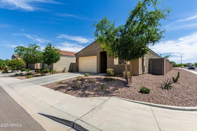 4269 W Coneflower Ln, San Tan Valley, AZ 85144 - view of front facade with concrete driveway, stucco siding, an attached garage, a tiled roof, and fence