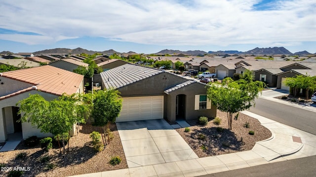 4269 W Coneflower Ln, San Tan Valley, AZ 85144 - view of front of home featuring a garage, concrete driveway, a tile roof, stucco siding, and a residential view