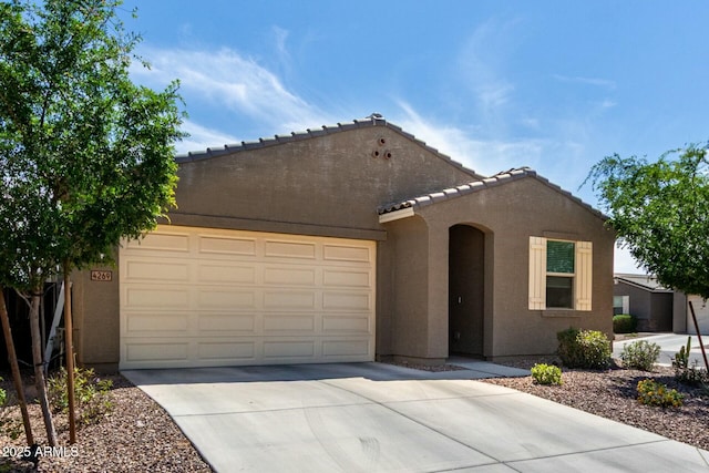 4269 W Coneflower Ln, San Tan Valley, AZ 85144 - view of front of house featuring an attached garage, driveway, a tiled roof, and stucco siding