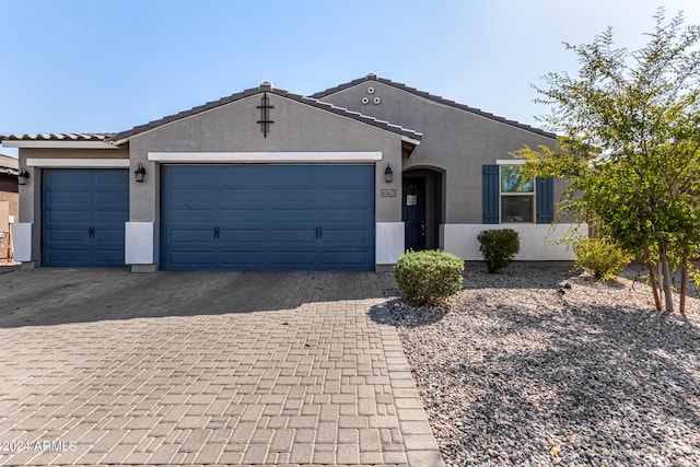 ranch-style home featuring a garage