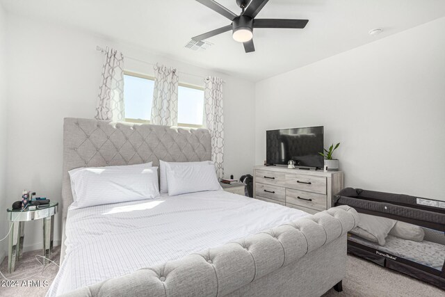 bedroom featuring light carpet and ceiling fan