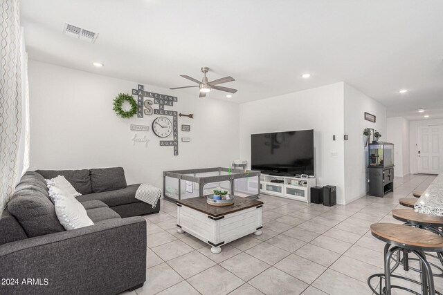 tiled living room featuring ceiling fan