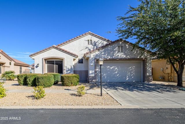 mediterranean / spanish home featuring a garage, driveway, a tiled roof, and stucco siding