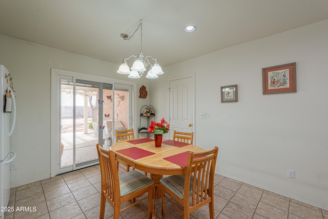 dining area with light tile patterned floors and a notable chandelier