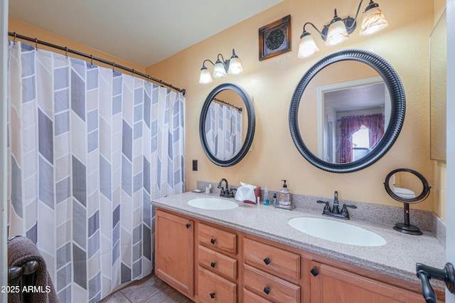 bathroom featuring tile patterned flooring, double vanity, and a sink