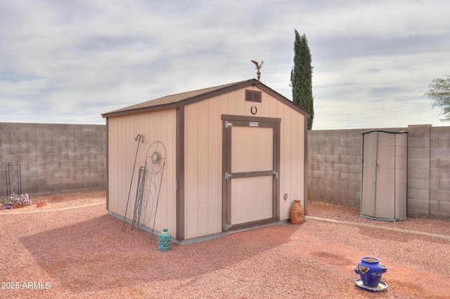 view of shed featuring a fenced backyard