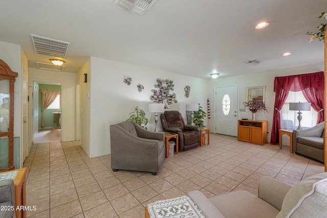 living area with light tile patterned flooring, recessed lighting, and visible vents