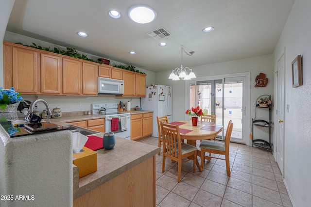 kitchen with a chandelier, visible vents, recessed lighting, and white appliances