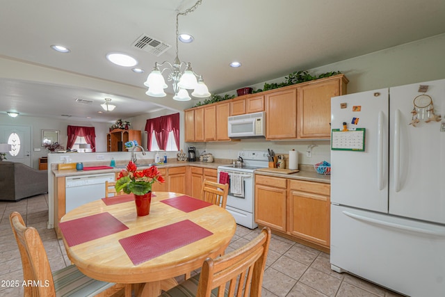 kitchen with visible vents, a notable chandelier, white appliances, a peninsula, and light countertops