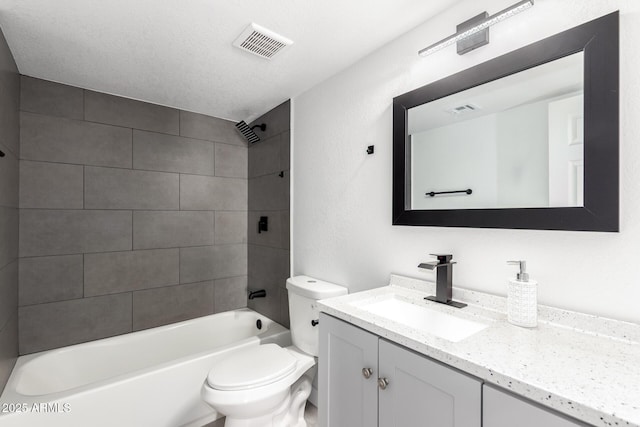 bathroom featuring visible vents, toilet, vanity, and shower / tub combination