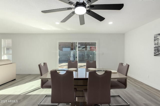 dining room featuring light wood-style floors, baseboards, and recessed lighting