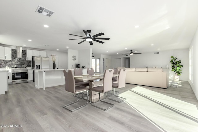 dining room with recessed lighting, visible vents, and light wood-style flooring