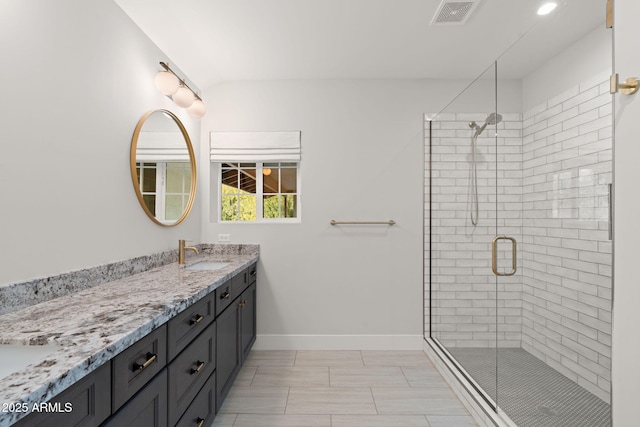 bathroom featuring vanity and a shower with shower door