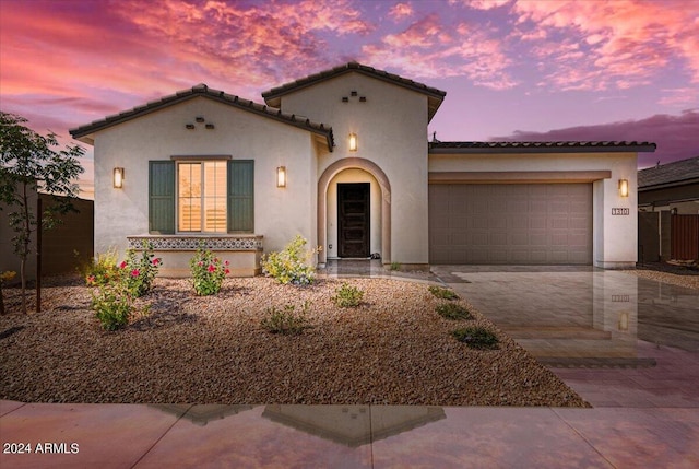 mediterranean / spanish-style home featuring a garage